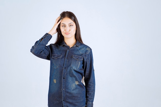 Young woman holding her head and thinking