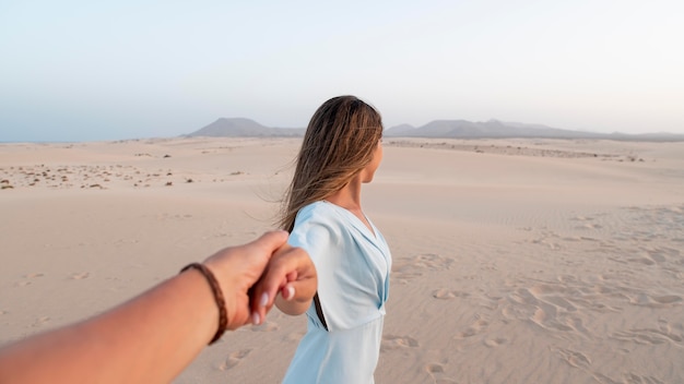 Young woman holding her partner hand while traveling