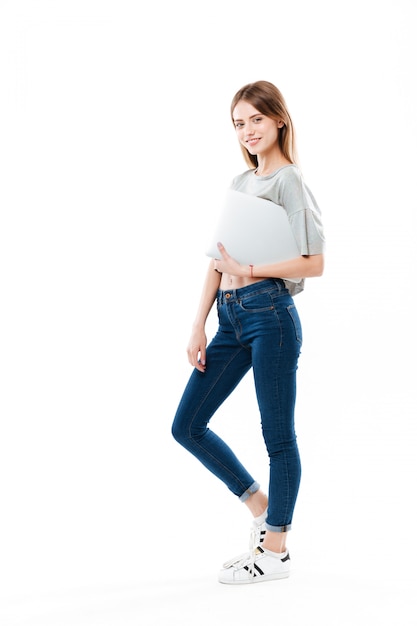 Young woman holding laptop computer