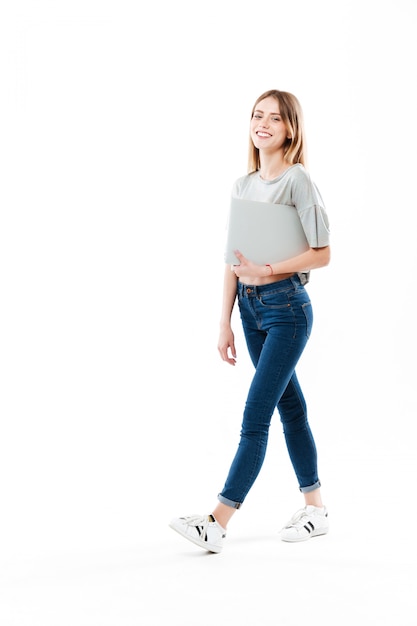 Young woman holding laptop computer