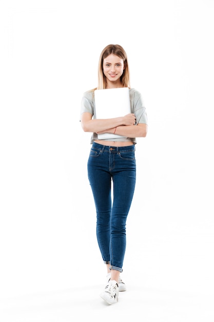 Young woman holding laptop computer