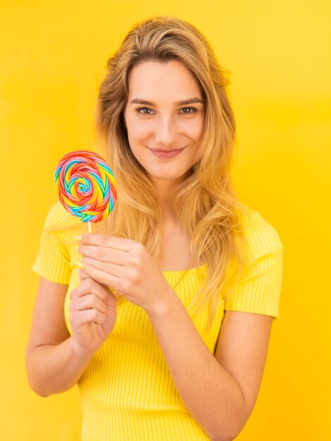 Young woman holding lollipop