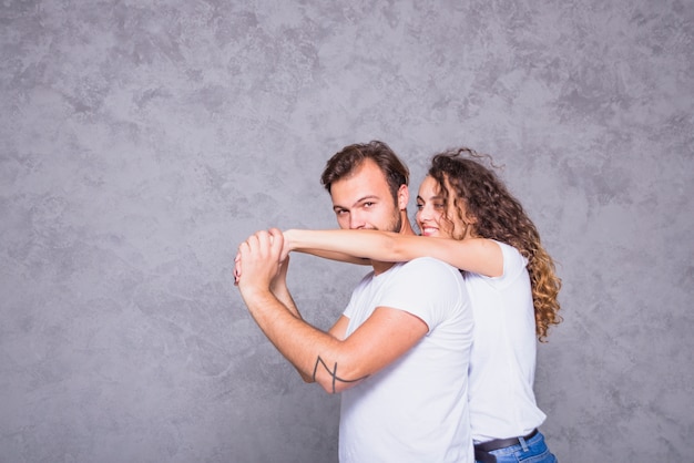 Young woman holding man from behind