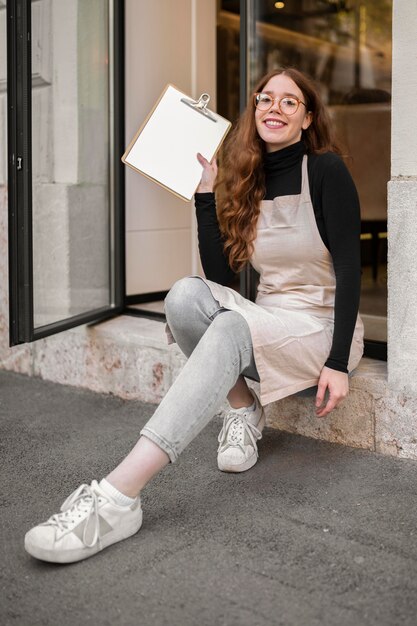 Young woman holding menu