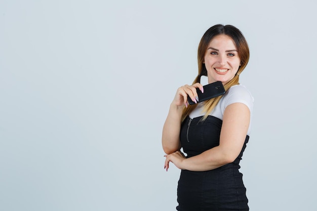 Young woman holding mobile phone