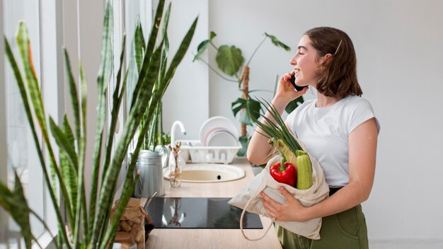 Young woman holding organic vegetables