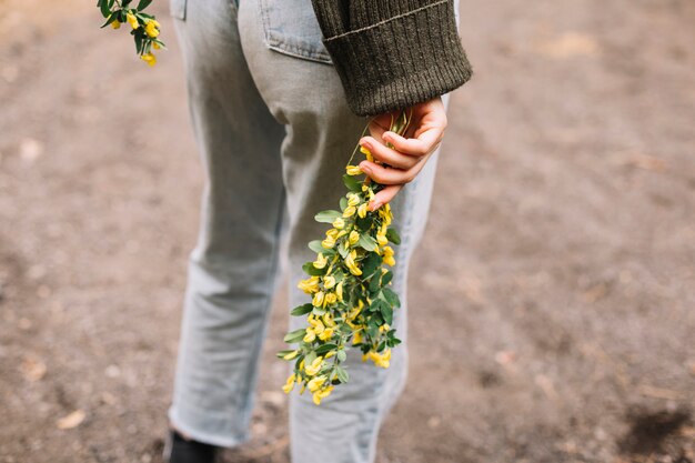 Young woman holding some wildflowers