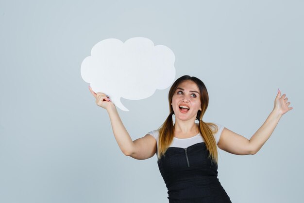 Young woman holding speech bubble