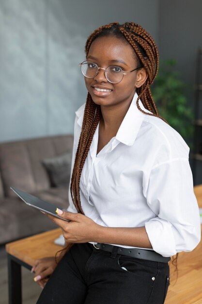 Young woman holding a tablet at work
