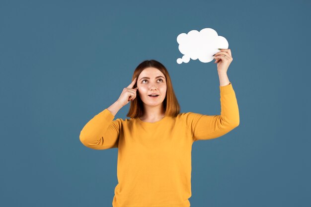 Young woman holding a thought bubble