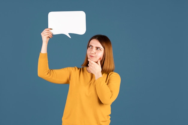 Young woman holding a thought bubble