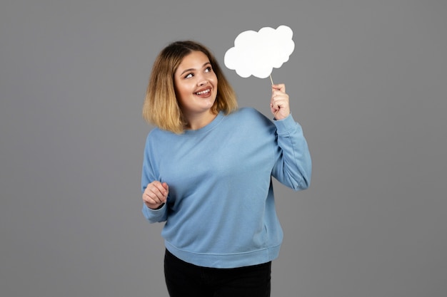 Young woman holding a thought bubble