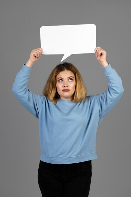 Young woman holding a thought bubble