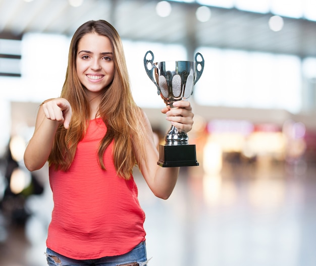 young woman holding a trophy on a white background