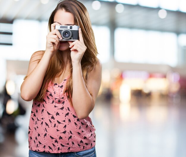 young woman holding a vintage camera