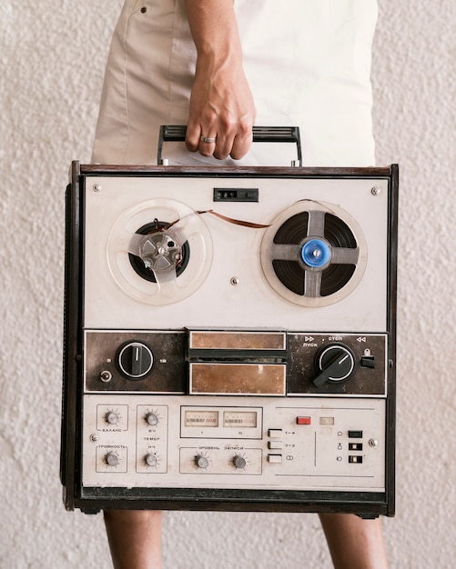 Young woman holding vintage record player