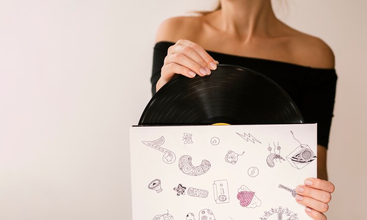 Free Photo young woman holding vinyl record in its case
