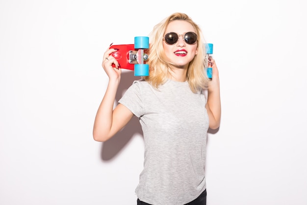 Young woman holds red skateboard behind her head