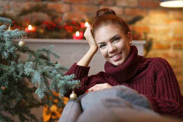 Young woman at home with Christmas decoration