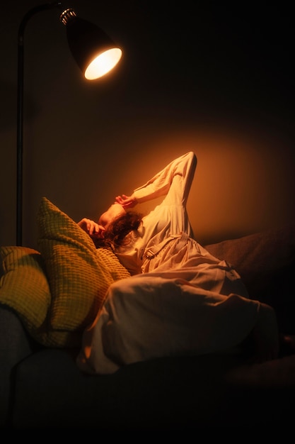 Young woman at home with mysterious interior lights around her