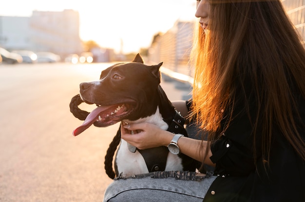 Free photo young woman hugging her pitbull