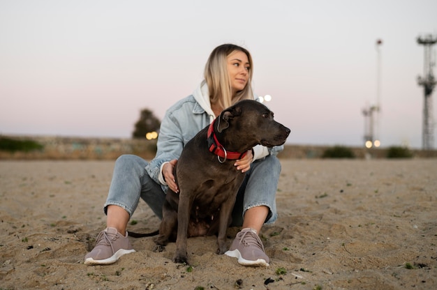 Young woman hugging her pitbull