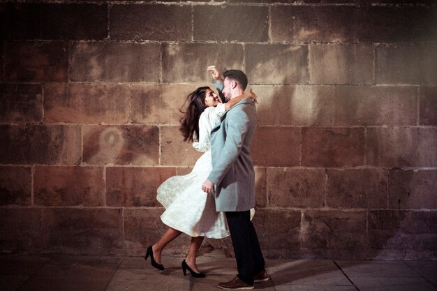 Young woman hugging man in street 