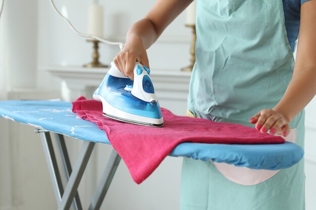 Young woman ironing the clothes