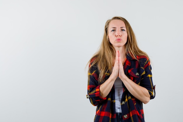 The young woman is begging on white background