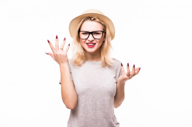 Young woman is holding her face in astonishment, isolated over white wall