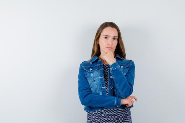 The young woman is thinking by putting hand on chin on white background