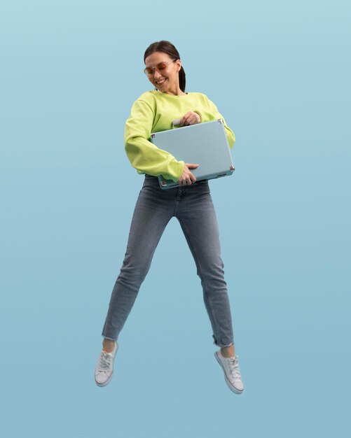 Young woman jumping isolated on blue