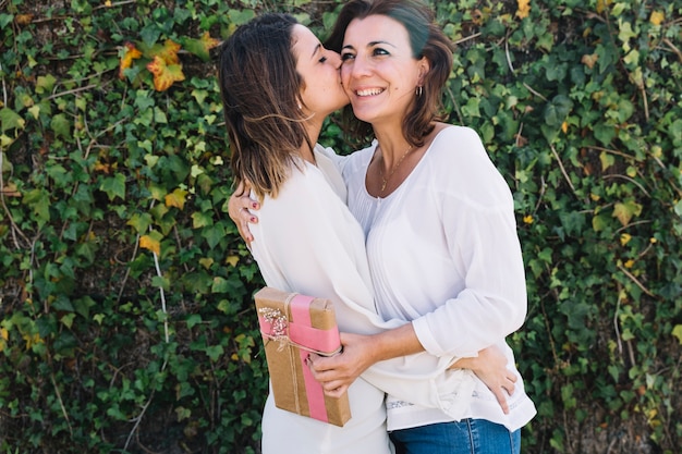 Young woman kissing and embracing woman