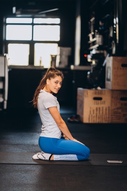 Young woman kneeling on the floor