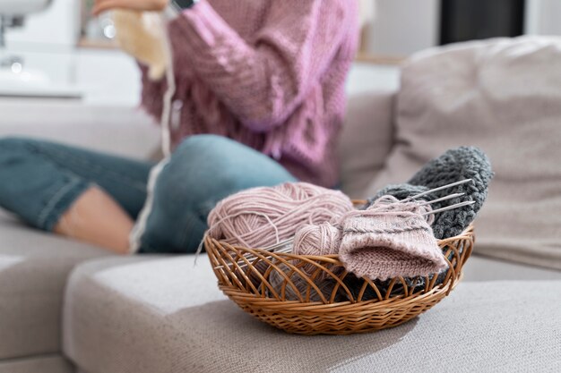 Young woman knitting while relaxing