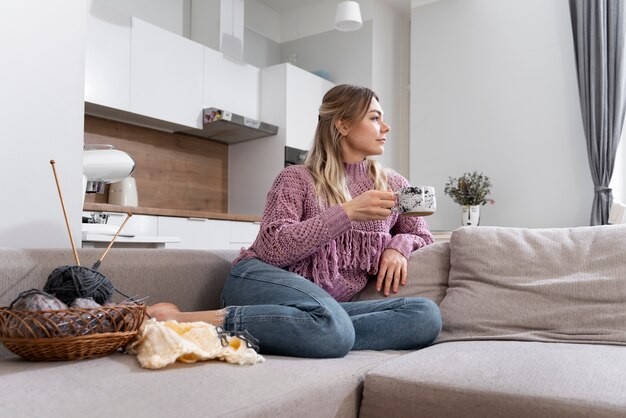 Young woman knitting while relaxing