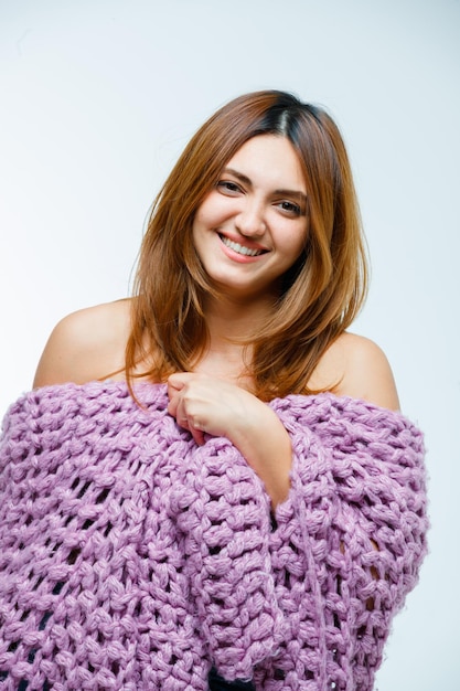 Young woman in knitwear laughing