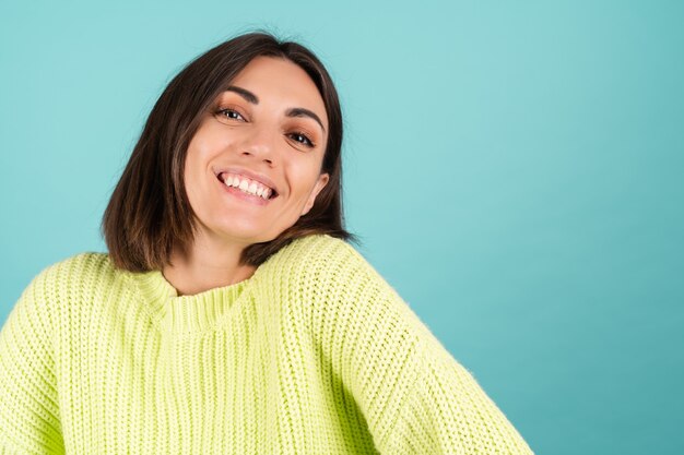 Young woman in light green sweater smiling