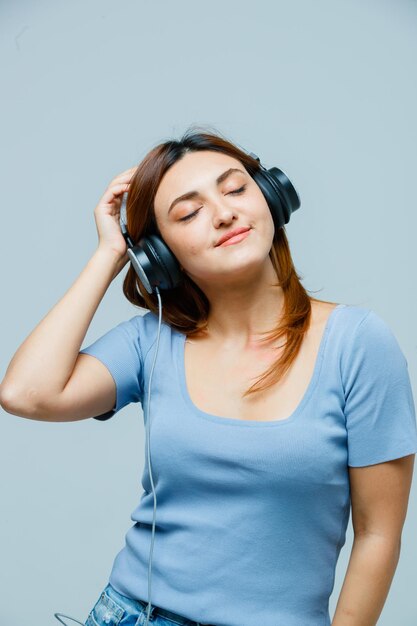 Young woman listening to music on headphones