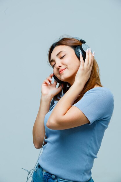 Young woman listening to music on headphones