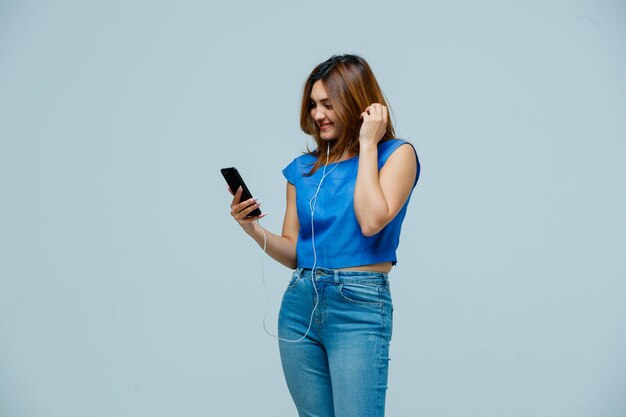 Young woman listening to music with earphones