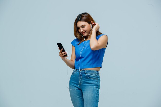 Young woman listening to music with earphones