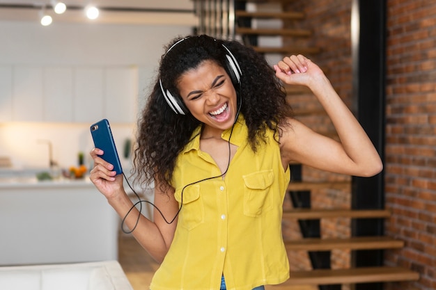 Free photo young woman listening to music