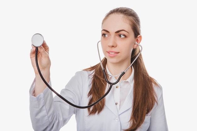 Young woman listening with stethoscope