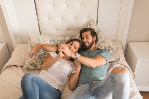 Young woman looking at hand of boyfriend