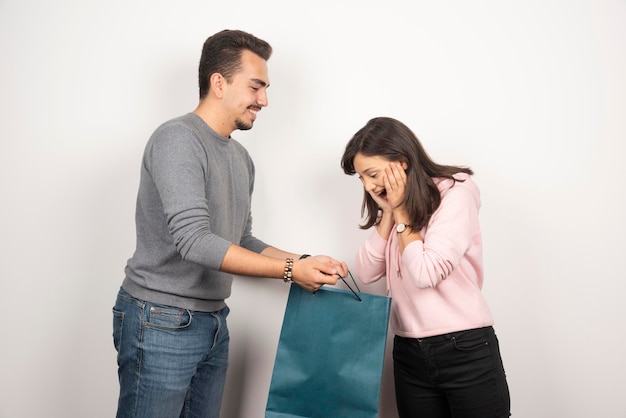 Young woman looking happy about her present from her boyfriend.