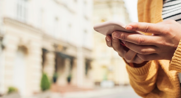 Young woman looking at her phone close-up