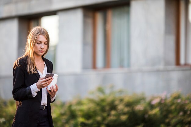 Young woman looking at phone mid shot