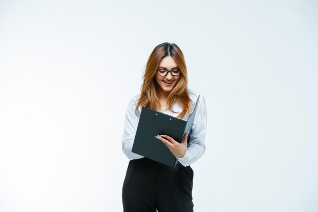 Young woman looking through clipboard