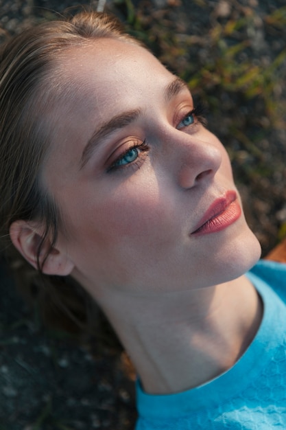 Young  woman looking up with bright face